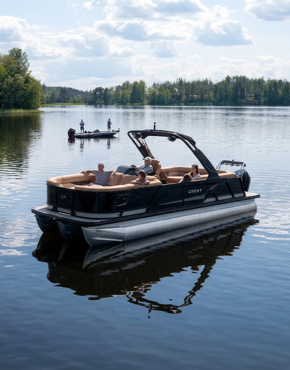 property-slider-Lakeside Lots A tritoon pontoon boat on the lake with a bass boat in the distance