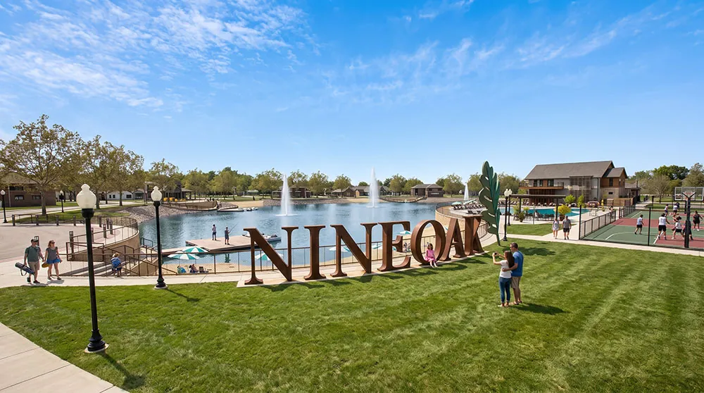 Nine-Oak-Social-Media-at-lake-sm-optimized aerial view of the Nine Oak town center with NINEOAK sign in front of the pond